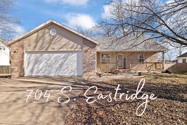 ranch-style home with a garage and covered porch