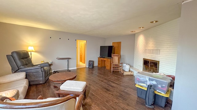 living room with a fireplace and dark hardwood / wood-style floors