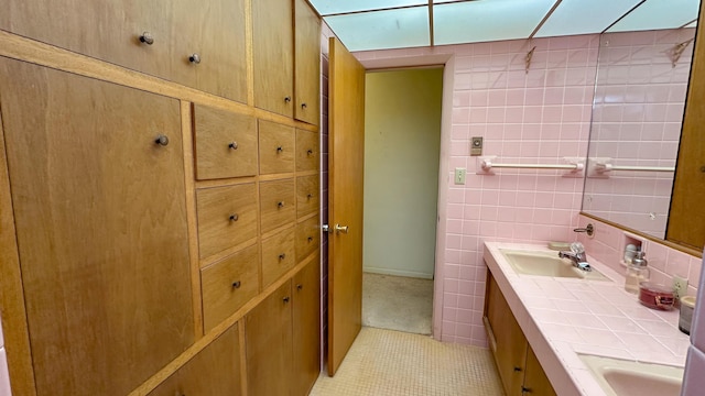 bathroom featuring vanity, tile walls, and tile patterned floors