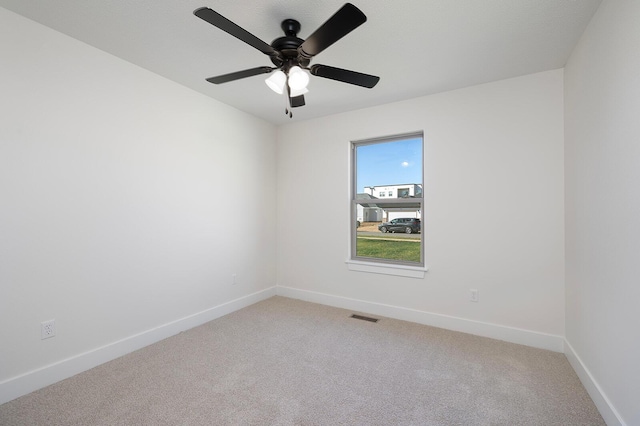 carpeted empty room featuring ceiling fan