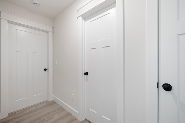 corridor with light hardwood / wood-style flooring