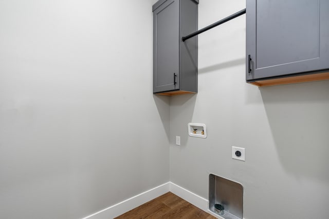 laundry area featuring cabinets, hookup for a washing machine, dark hardwood / wood-style floors, and hookup for an electric dryer