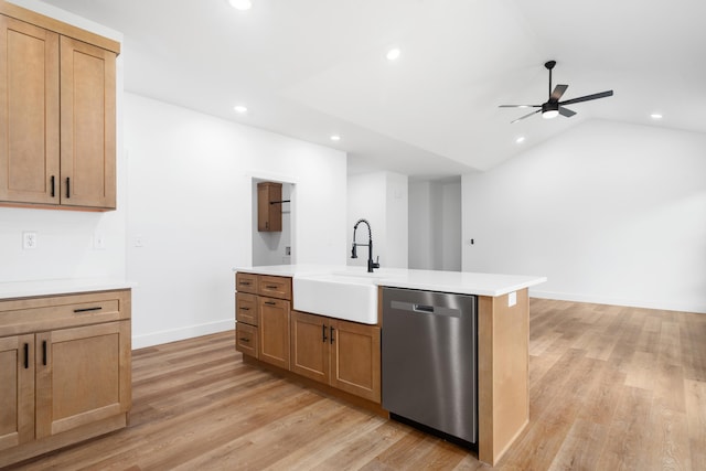 kitchen featuring lofted ceiling, sink, dishwasher, an island with sink, and light wood-type flooring