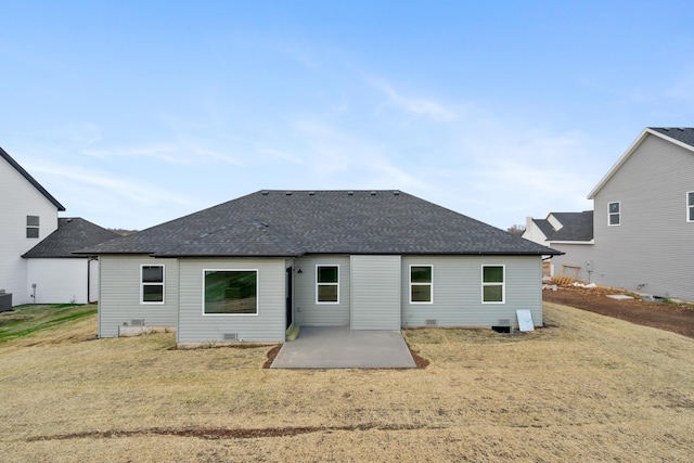 back of property featuring a patio and a lawn