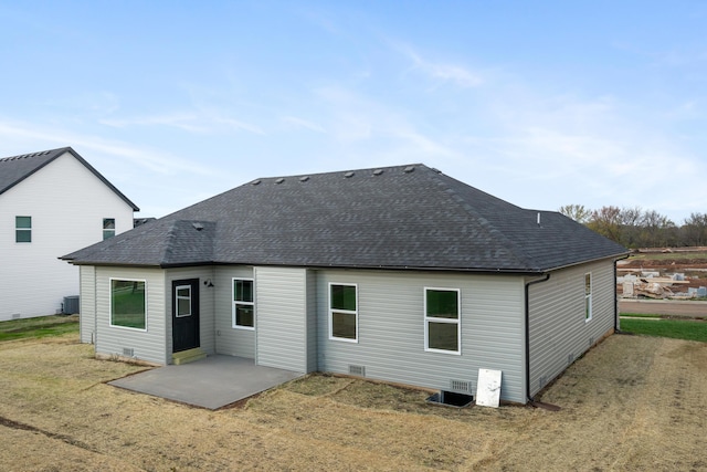 back of house with cooling unit, a patio area, and a lawn