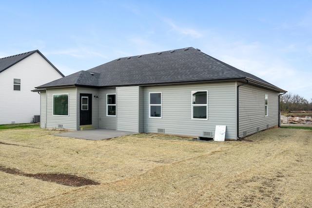 rear view of property featuring a lawn, central air condition unit, and a patio area