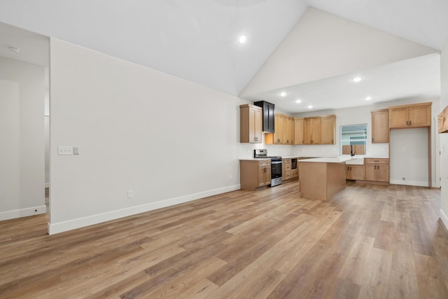 kitchen with high vaulted ceiling, light wood-type flooring, stainless steel stove, and a kitchen island