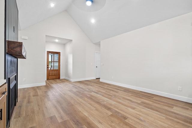 unfurnished living room featuring light hardwood / wood-style floors and high vaulted ceiling