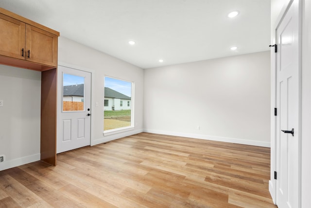 interior space featuring light hardwood / wood-style floors and a barn door