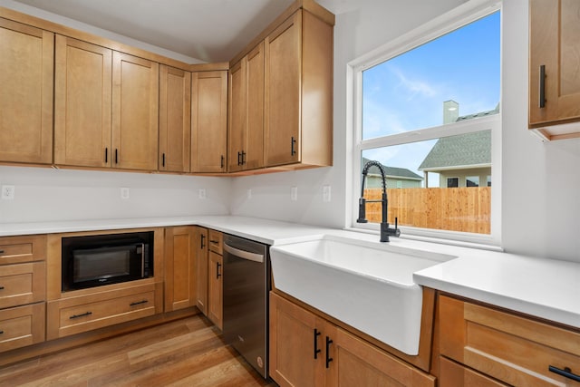 kitchen with sink, light hardwood / wood-style flooring, dishwasher, and black microwave