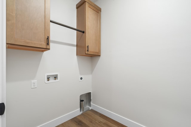 laundry area featuring washer hookup, cabinets, wood-type flooring, and electric dryer hookup