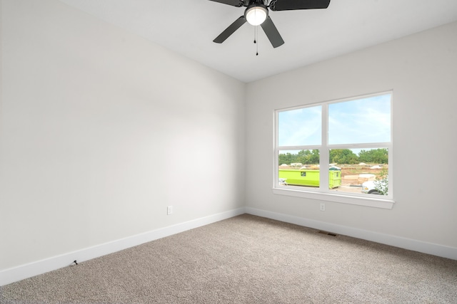 carpeted spare room featuring ceiling fan