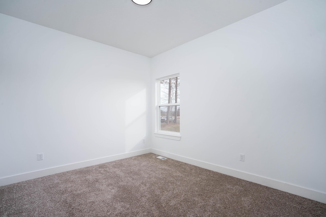unfurnished room with baseboards, visible vents, and carpet floors