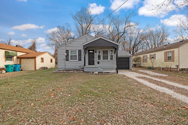 bungalow-style home with a garage and a front lawn