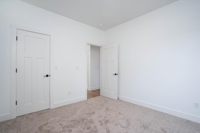 unfurnished bedroom featuring light carpet