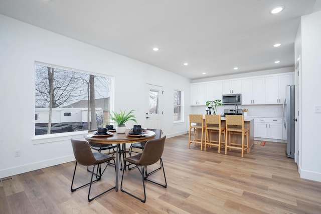 dining area with light hardwood / wood-style floors