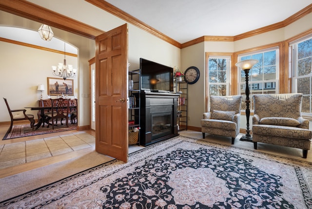 living room featuring crown molding and a notable chandelier