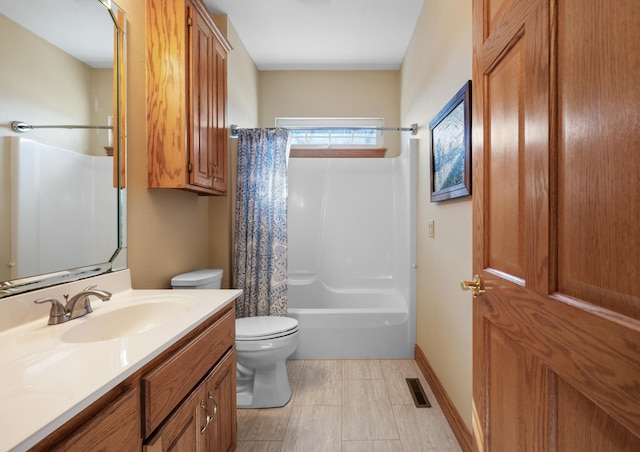 full bathroom with vanity, shower / bath combo, and toilet