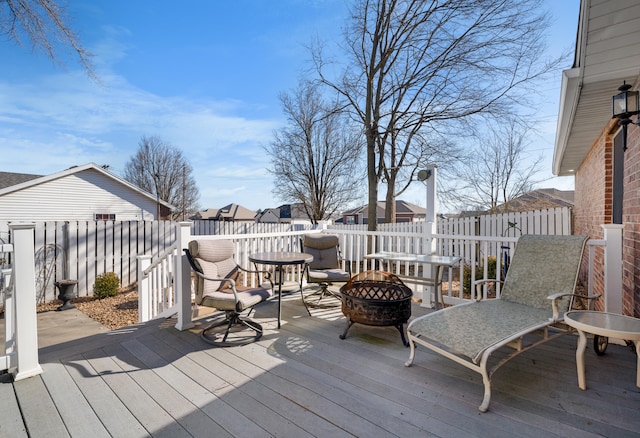 wooden deck with a fire pit