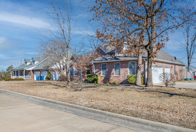 view of front of property with a garage and a front lawn