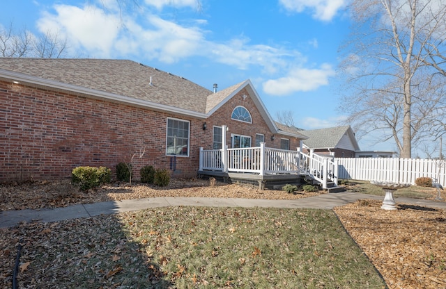 exterior space featuring a deck and a front lawn