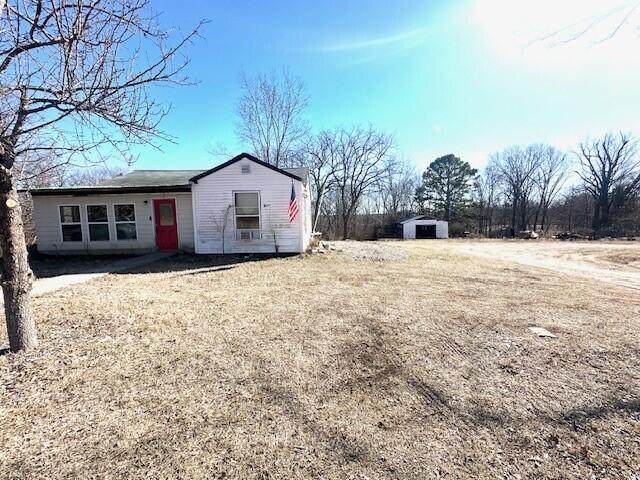 exterior space featuring a shed