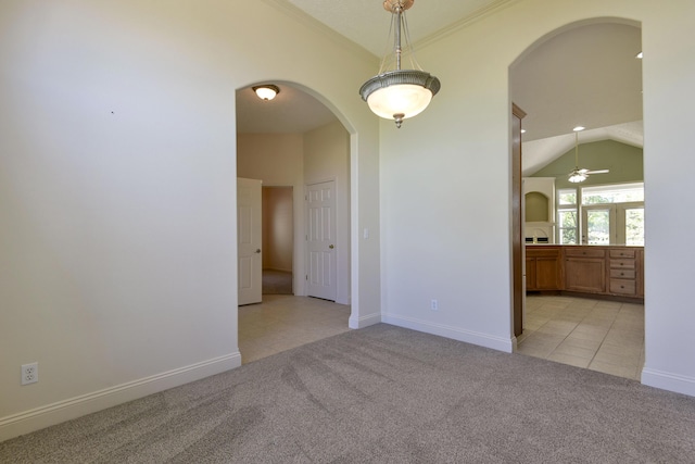 empty room with light tile patterned flooring, ceiling fan, and lofted ceiling