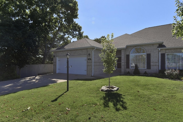 ranch-style house featuring a garage and a front yard