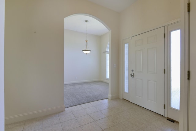 foyer entrance featuring light tile patterned floors and plenty of natural light