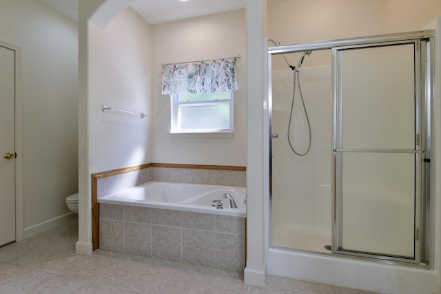 bathroom featuring toilet and separate shower and tub