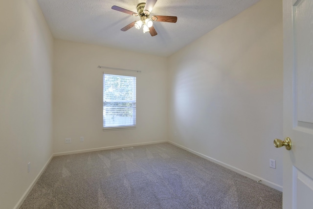 carpeted spare room with ceiling fan and a textured ceiling