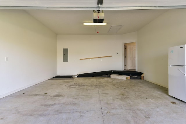 garage with white refrigerator, a garage door opener, and electric panel