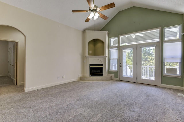 unfurnished living room featuring lofted ceiling, light colored carpet, and ceiling fan