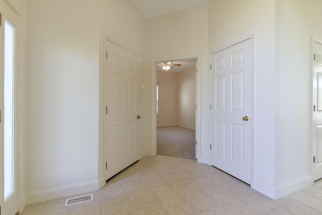 hall with light tile patterned floors