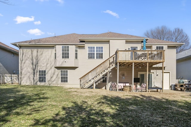 rear view of house featuring a yard and a deck