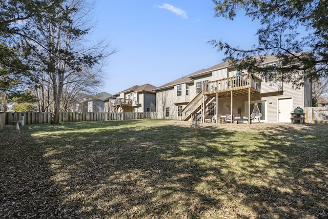 rear view of property featuring a deck and a lawn