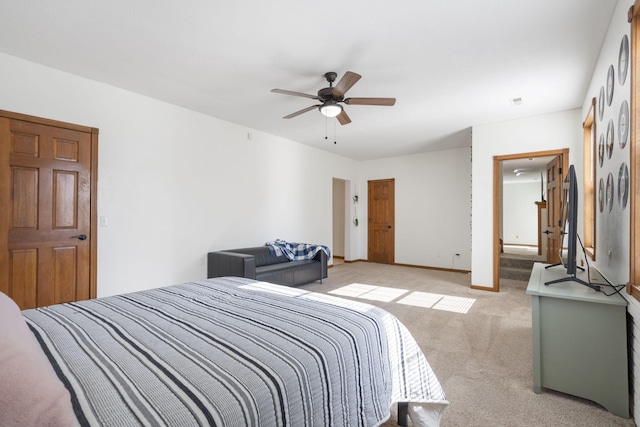 bedroom featuring light carpet and ceiling fan