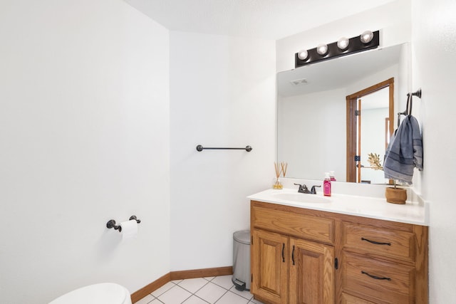 bathroom with tile patterned flooring, vanity, and toilet