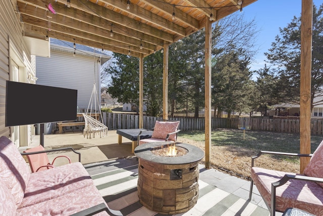 view of patio featuring an outdoor living space with a fire pit