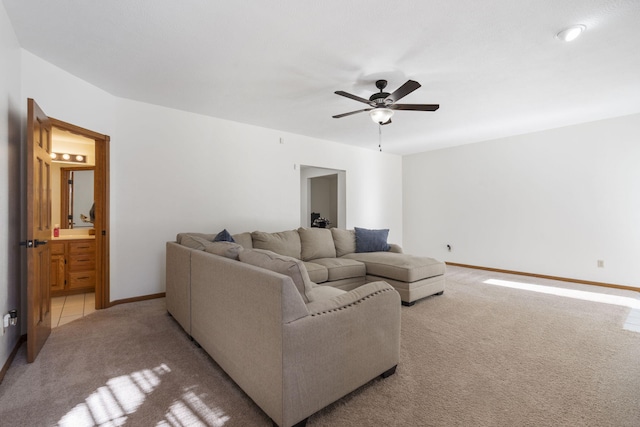 carpeted living room with ceiling fan