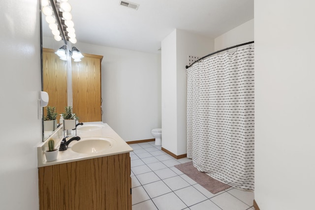 bathroom with vanity, curtained shower, tile patterned floors, and toilet