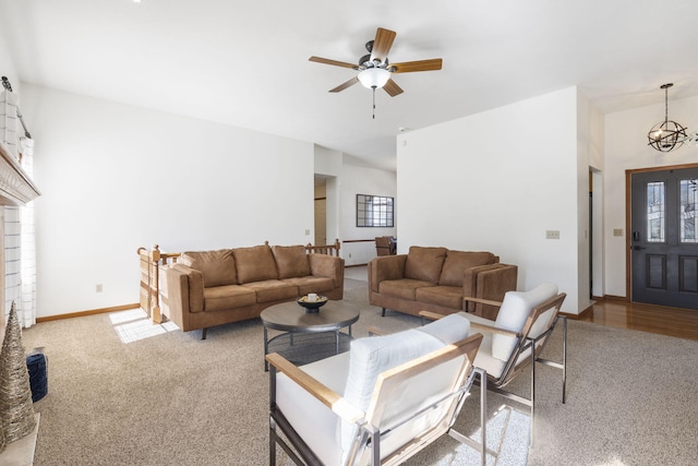 carpeted living room with ceiling fan with notable chandelier