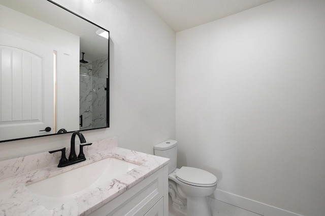 bathroom with vanity, toilet, tile patterned flooring, and a tile shower