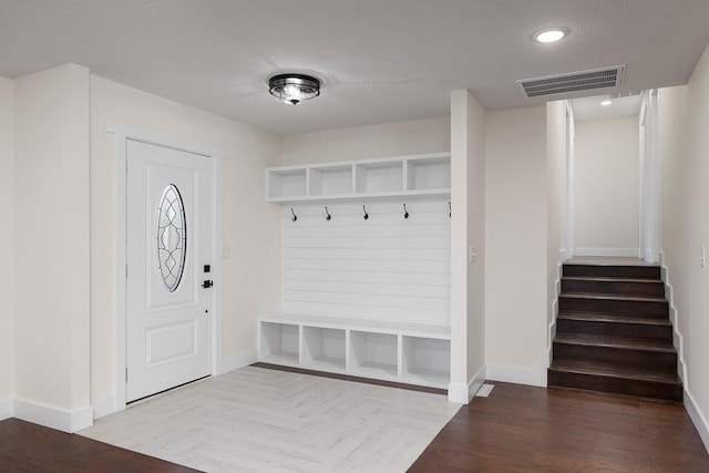 mudroom with parquet floors and a textured ceiling