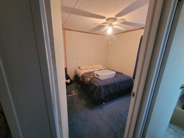 carpeted bedroom with ceiling fan and a textured ceiling