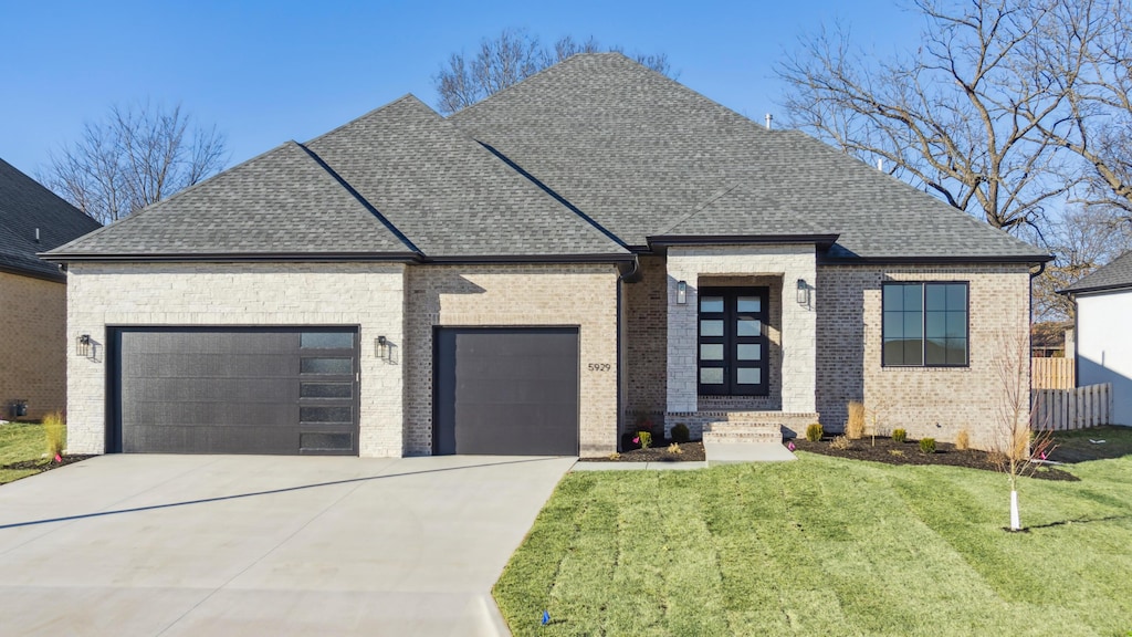 view of front of home with a garage and a front yard