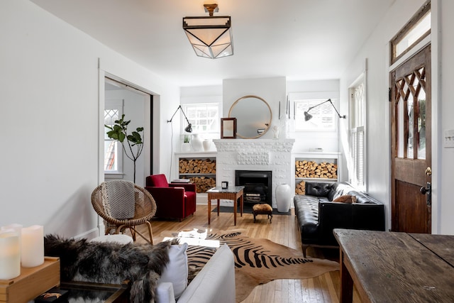 living area featuring hardwood / wood-style flooring and a fireplace