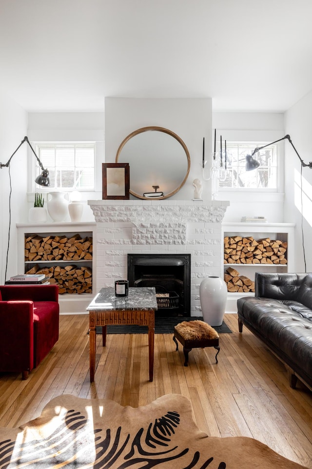 interior space featuring a brick fireplace and light wood-type flooring