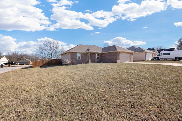 single story home featuring a garage and a front yard