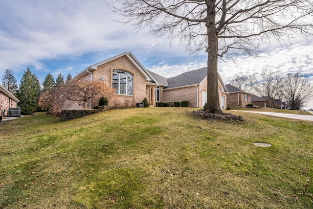 view of front property with central AC unit and a front lawn